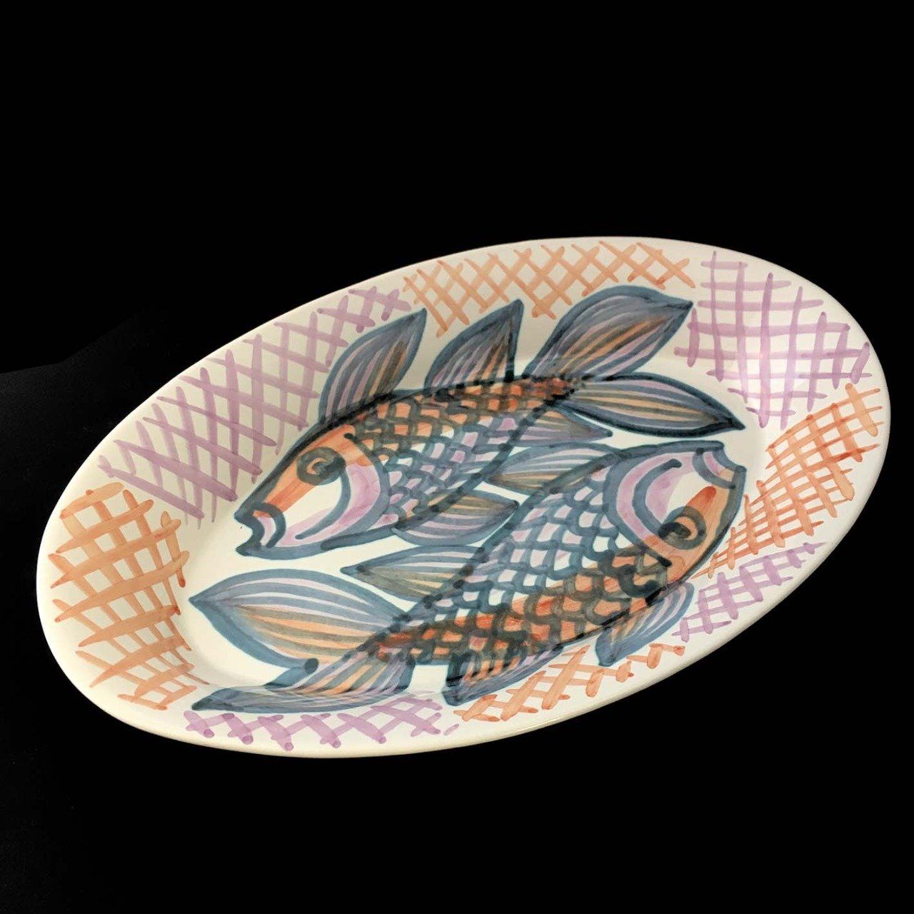 Plat ovale bords inclinés 35 cm X 21,8 cm faïence décor sur émail cru, poissons "tête-bêche"
